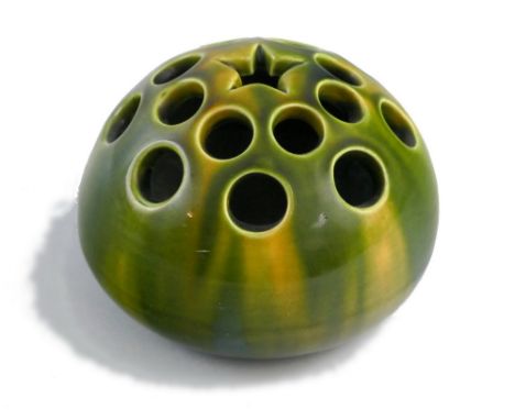 An Ault Pottery flower brick, designed by Christopher Dresser, of pierced ovoid form with central star and majolica style sha