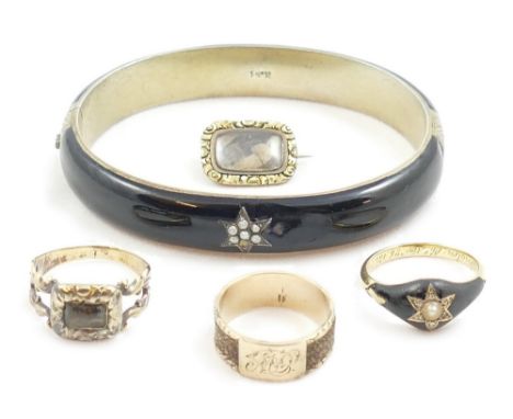 A Victorian gold, enamel, pearl and diamond mourning ring, the central star set with a half pearl and rose diamonds, locket b