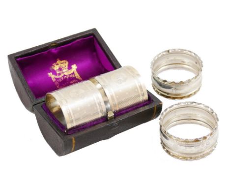 A Victorian silver pair of napkin rings, Sheffield 1877, of circular form with engine turned decoration, monogrammed, weight 