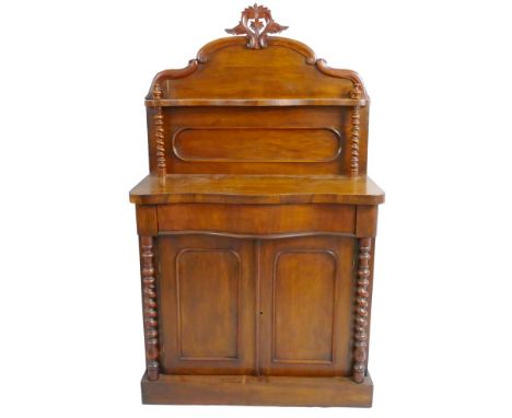 A Victorian walnut chiffonier, with carved and scrolling undulating top rail over a serpentine shelf and panelled back with b