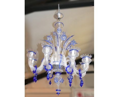 A Murano Italy chandelier, in blue edged clear glass, the central fluted baluster stem applied with flowerheads and leaves, t