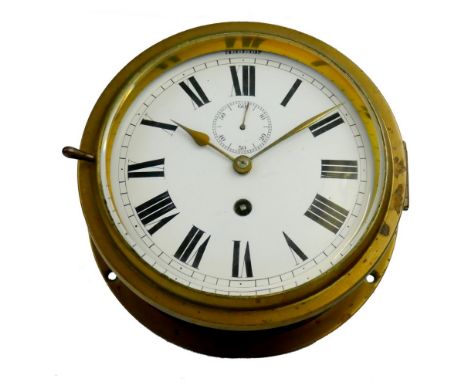 A late 19th/early 20th brass ships bulkhead clock, the white enamel dial with Roman numerals and subsidiary seconds dial, dia