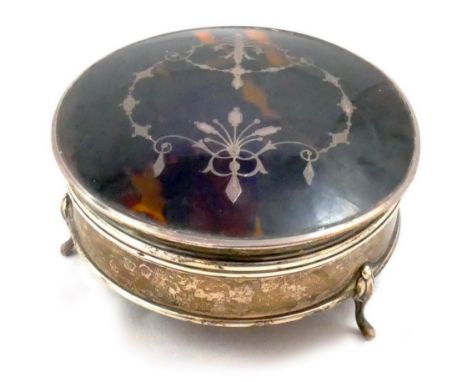 A tortoiseshell and silver trinket box, Birmingham 1927, of circular form, the hinged cover with pique work floral decoration