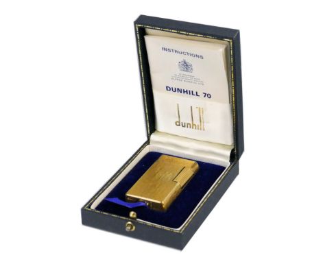 A Dunhill 70 gas lighter, of rounded oblong form with gold plated bark textured finish, serial no.CW904 6cm high in original 