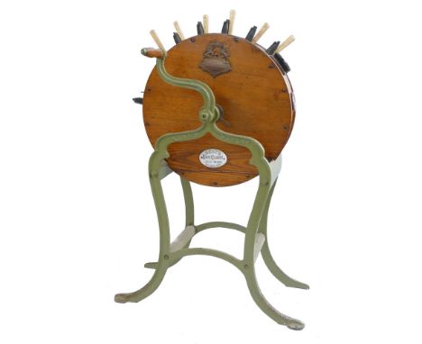 A Victorian Kent's Patent knife cleaner, of oak drum shaped form with seven polishing apertures, embossed brass and enamel ma