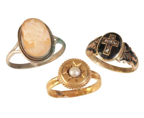 THREE GEM-SET RINGSincluding a pearl ring in 18ct gold, the head set with a split pearl in a star setting and ropework border
