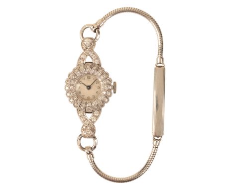 A LADY'S PLATINUM AND DIAMOND COCKTAIL WATCHwith manual wind movement, the circular white dial with black Arabic numerals and