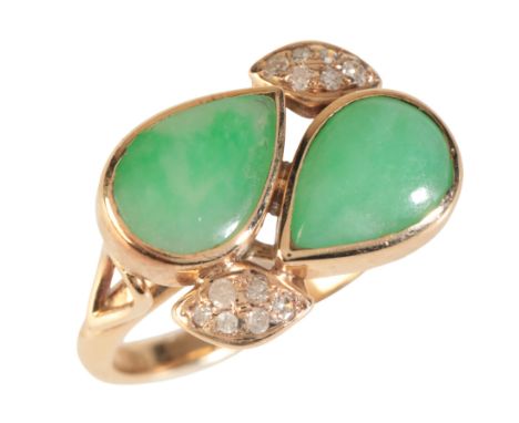 A JADE AND DIAMOND CROSS-OVER RINGin 9ct gold, set with two jadeite jade pear-shape cabochons held in bezel settings, accente