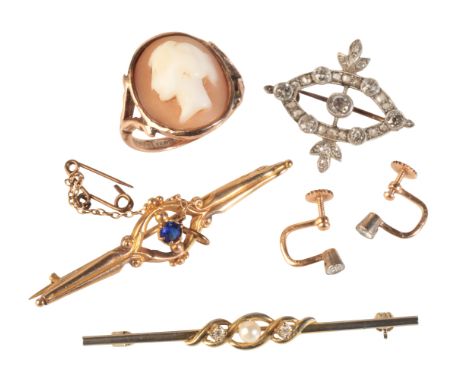 A DIAMOND BROOCHin silver on gold, set with seven principal old-cut diamonds over a stylised design, accented by rose-cut and