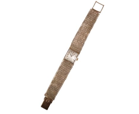 OMEGA: A LADY'S 9CT GOLD BRACELET WATCHwith manual wind movement, the silver dial with gold baton numerals and dark blue stee