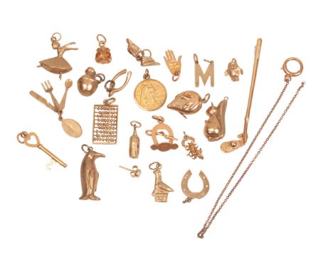 A COLLECTION OF GOLD CHARMSin 9ct gold, including a ballerina, a penguin, a golf club, a St Christopher pendant, a scorpion, 