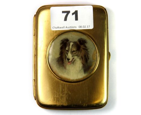 An early 20th century gold plated cigarette case, decorated with an panel of a border collie dogs head, L. 9cm.