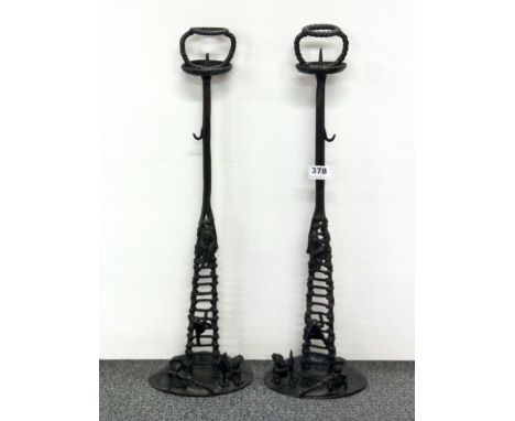 A pair of unusual oriental bronze candle sticks of figures around a ladder, H. 55cm.