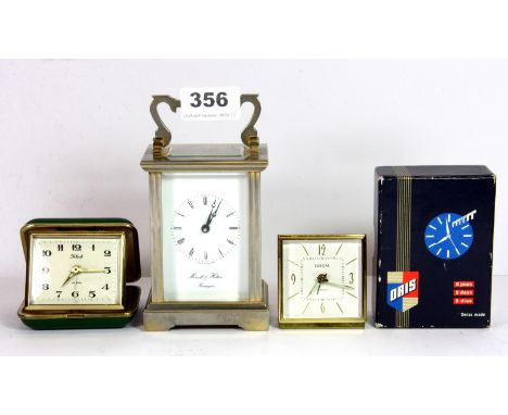A carriage clock and two travel clocks