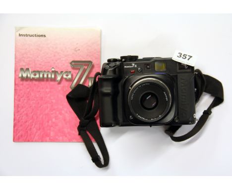 A Mamiya 7 II camera with Mamiya 1-4 F=80mm lens and instruction leaflet.