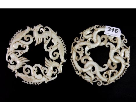 A pair of fine Chinese carved jade discs of dragons and phoenix, Dia. 14cm, Prov. a private local collection.