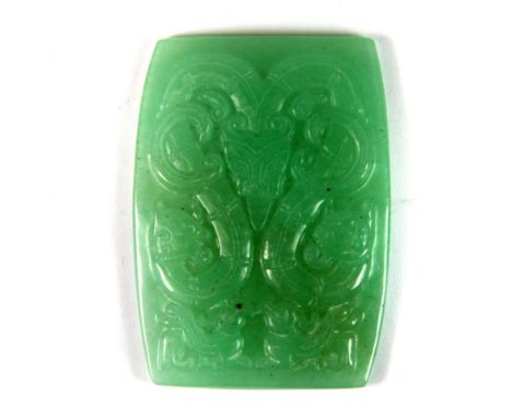 An early 20th century Chinese carved apple green jade panel (probably from the top of a box) featuring two dragons with their