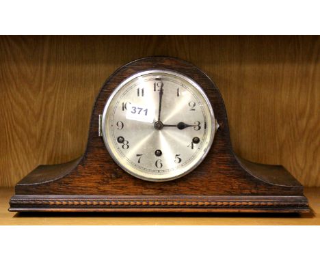 A chiming oak mantle clock, W. 42cm.