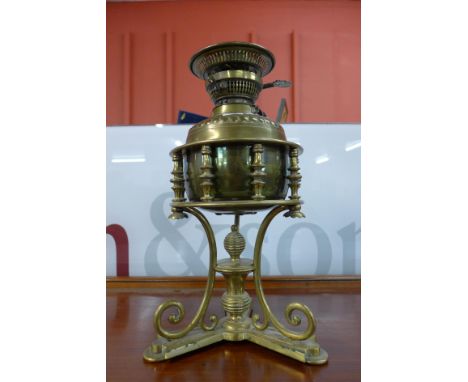 A Victorian Aesthetic Movement brass oil lamp, manner of W.A.S. Benson 