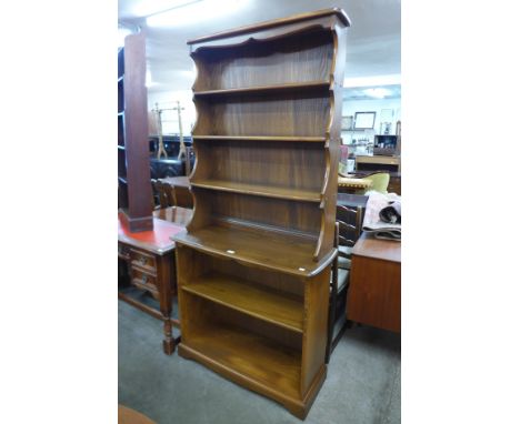 An Ercol Golden Dawn elm open bookcase 