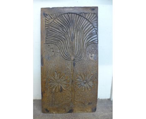 A 17th Century oak panel, carved with carnation and roses 