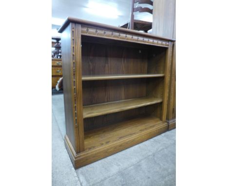 An Ercol Golden Dawn elm open bookcase 