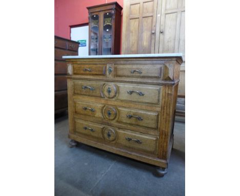 A French provincial oak and marble topped commode 