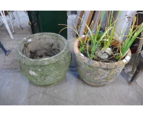A terracotta garden planter and a concrete garden planter 