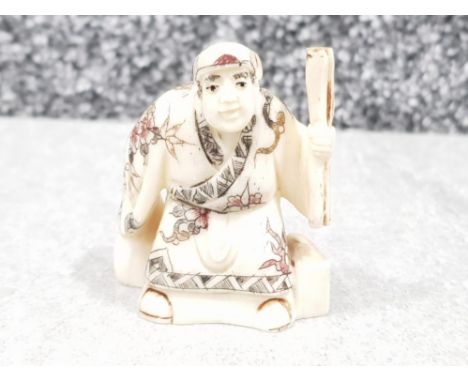 Japanese handcarved bone Netsuke in the form of a village elder with scroll