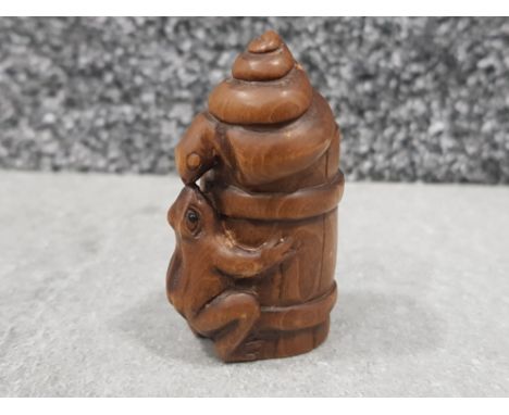 Handcarved hardwood Netsuke in the form of frog &amp; snail on barrel, signed on base