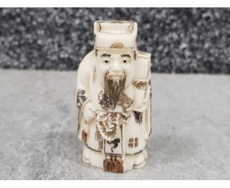 Japanese handcarved bone Netsuke in the form of a village elder with scroll