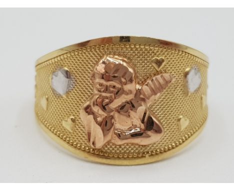 A 10ct yellow rose and white gold dress ring with cherub motif size O1/2 3.11g new and in very good condition