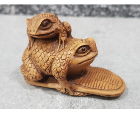 Handcarved hardwood Netsuke in the form of two Toads