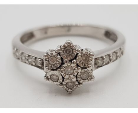 Ladies 9ct white gold diamond cluster ring, comprising of 7 stones set in the centre with 4 diamonds set on each shoulder, si
