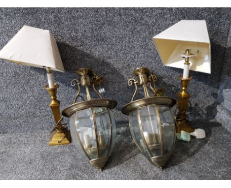 A pair of brass table lamps and a pair of brass and bevelled glass hall lantern style light fittings.