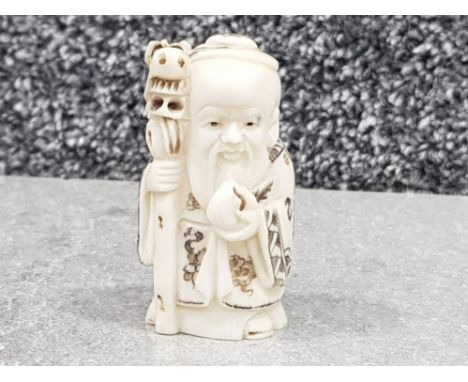 Japanese handcarved bone Netsuke in the form of village seer with shaman staff