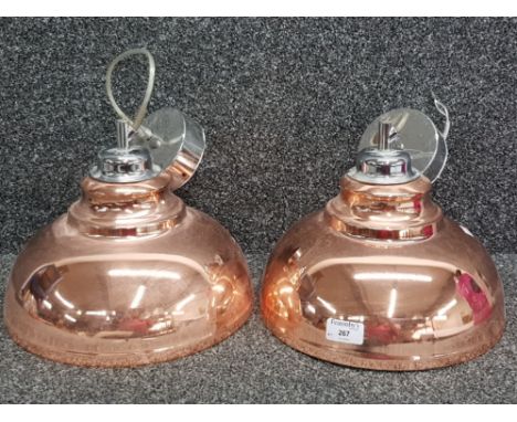 A pair of industurial style copper effect ceiling light fittings.