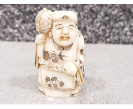 Japanese handcarved bone Netsuke in the form of a village elder with hammer