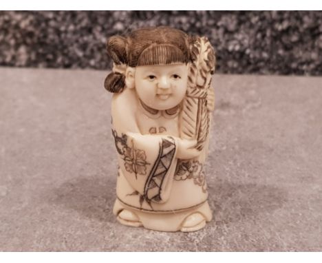 Japanese handcarved Bone Netsuke in the form of a old lady carrying flowers