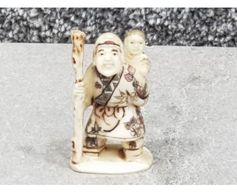 Japanese handcarved bone Netsuke in the form of man carrying child