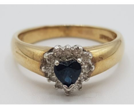Ladies 9ct yellow gold sapphire and diamond cluster ring, set with black heart shaped sapphire in the centre surrounded by 12