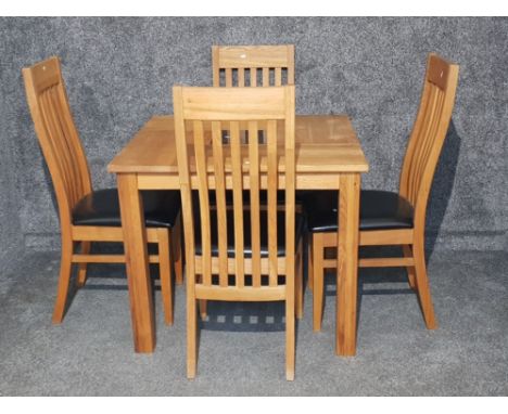 A light oak dinning room table and four chairs.