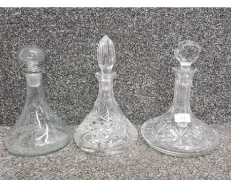 Two cut glass ship's decanters and another ship's decanter.