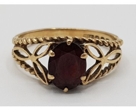 A 9ct yellow gold and garnet fancy ring size M1/2 2.26g gross