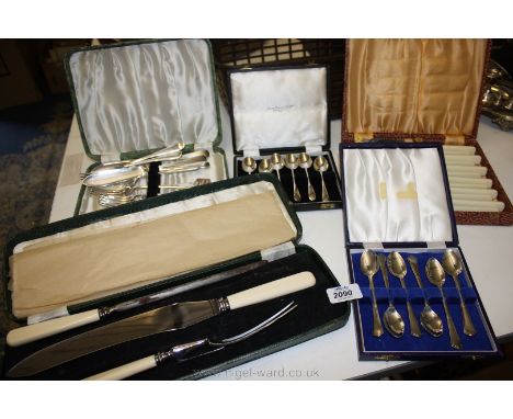 A cased three piece Carving set, two cased six place fish knife and fork sets and two cased six piece Teaspoon sets