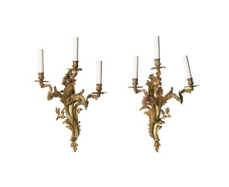  PAIR OF FRENCH GILT BRONZE WALL LIGHTS 19TH CENTURY in the Louis XV style, of rococo form, the foliate back plates issuing t