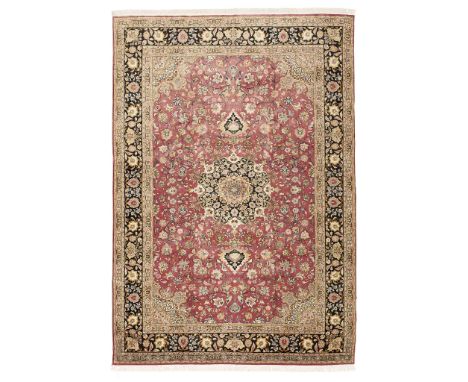  TABRIZ CARPET NORTHWEST PERSIA, MID/LATE 20TH CENTURY the puce field with black and light brown medallion, light brown spand