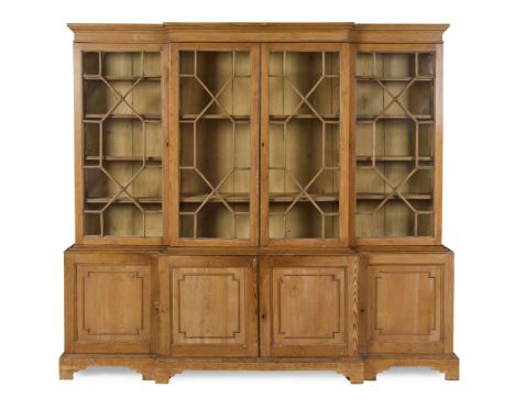 GEORGE III STRIPPED PINE BREAKFRONT BOOKCASE LATE 18TH CENTURY with a plain moulded cornice and frieze, abpve a central pair