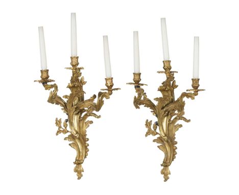  PAIR OF FRENCH GILT BRONZE WALL LIGHTS 19TH CENTURY in the Louis XV style, of rococo form, the foliate back plates issuing t