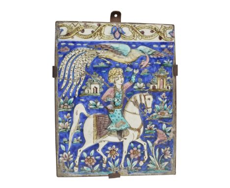  PERSIAN POLYCHROME TIN-GLAZED TILE  relief moulded depicting an equestrian figure with a peacock, against a field of flowers